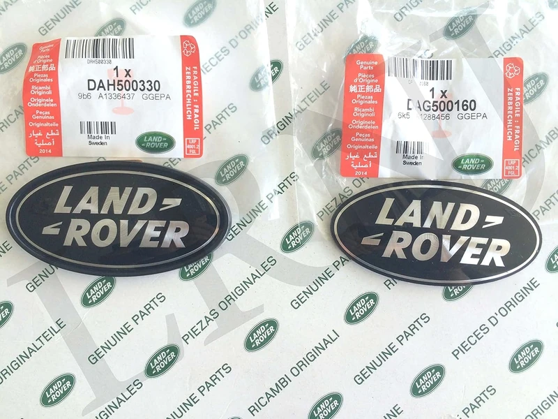 Land Rover about OVAL BADGES BLACK ON SILVER -NEW GENUINE PARTS DAG500160 + DAH500330 - Image 1