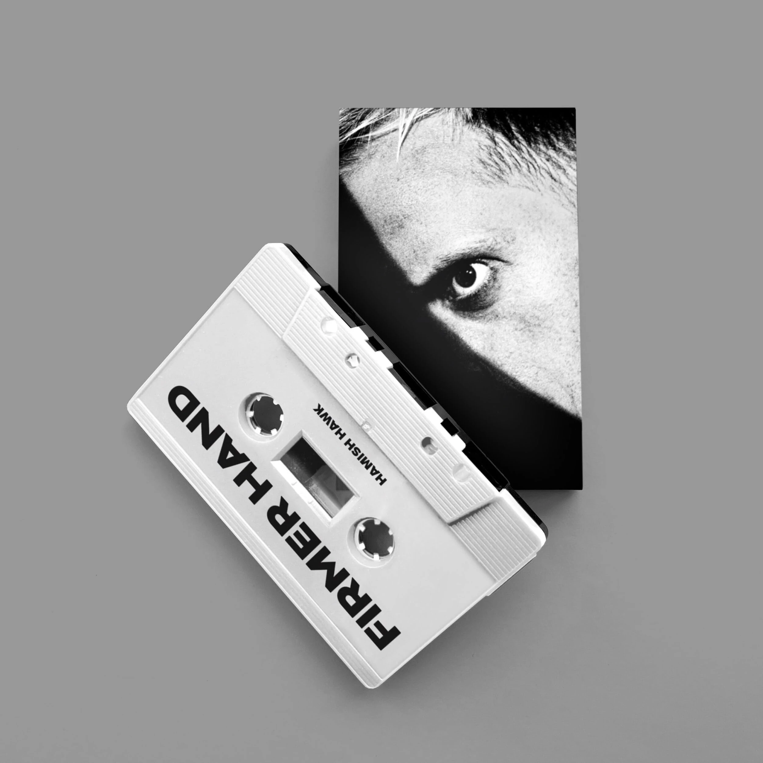 A FIRMER HAND (WHITE/BLACK) [CASSETTE]